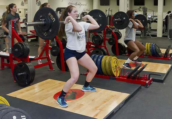 weintraub gym-1 sWEB - Taylor Kline, 18, (left) and Danetta Boykin, 19, members of the Pierce College Women's Volleyball team work out lifting weights in the Pierce Fitness Center in Woodland Hills, Calif. on Thursday, Feb. 23, 2012. Photo by Ava Weintraub
